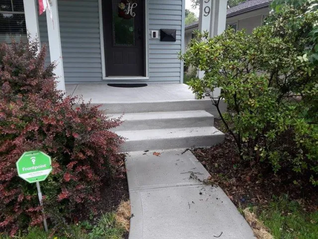 New concrete walkway and front porch leading into front door of Columbus home