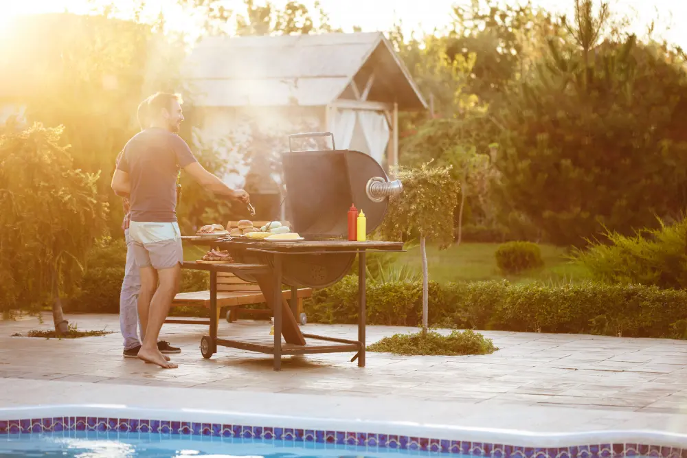 Outdoor kitchen setup with homeowner cooking in sunlight