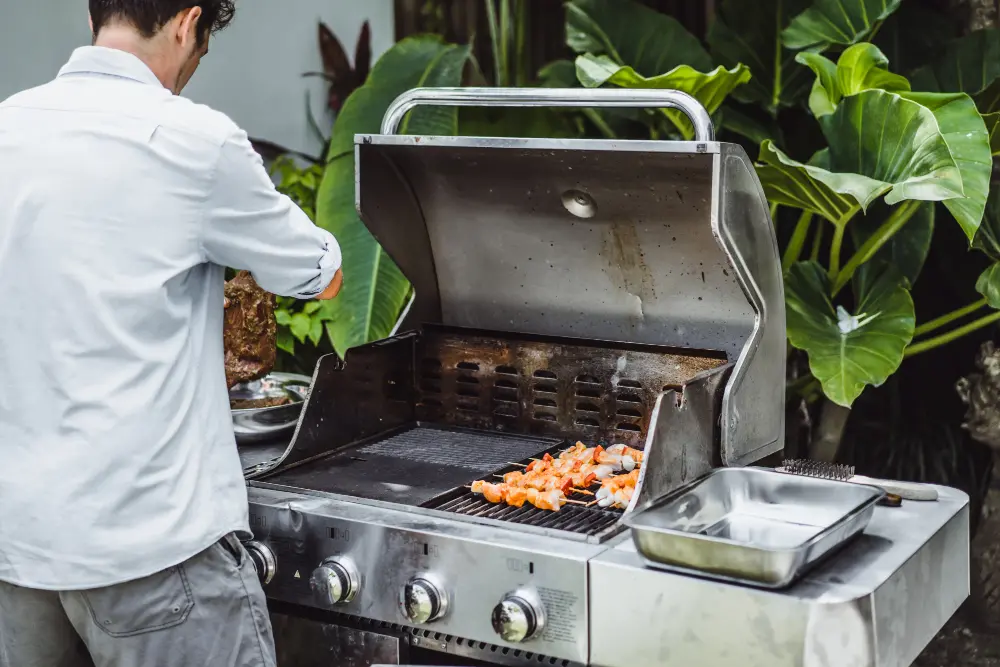 Backyard outdoor kitchen with person preparing food