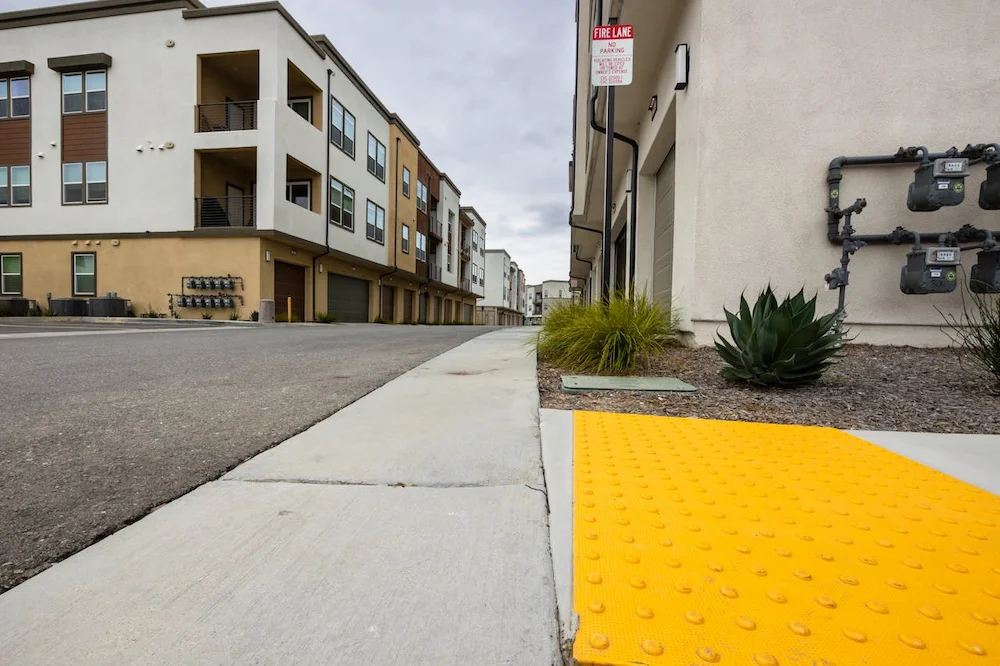 ADA compliant sidewalk ramp with tactile warning indicators