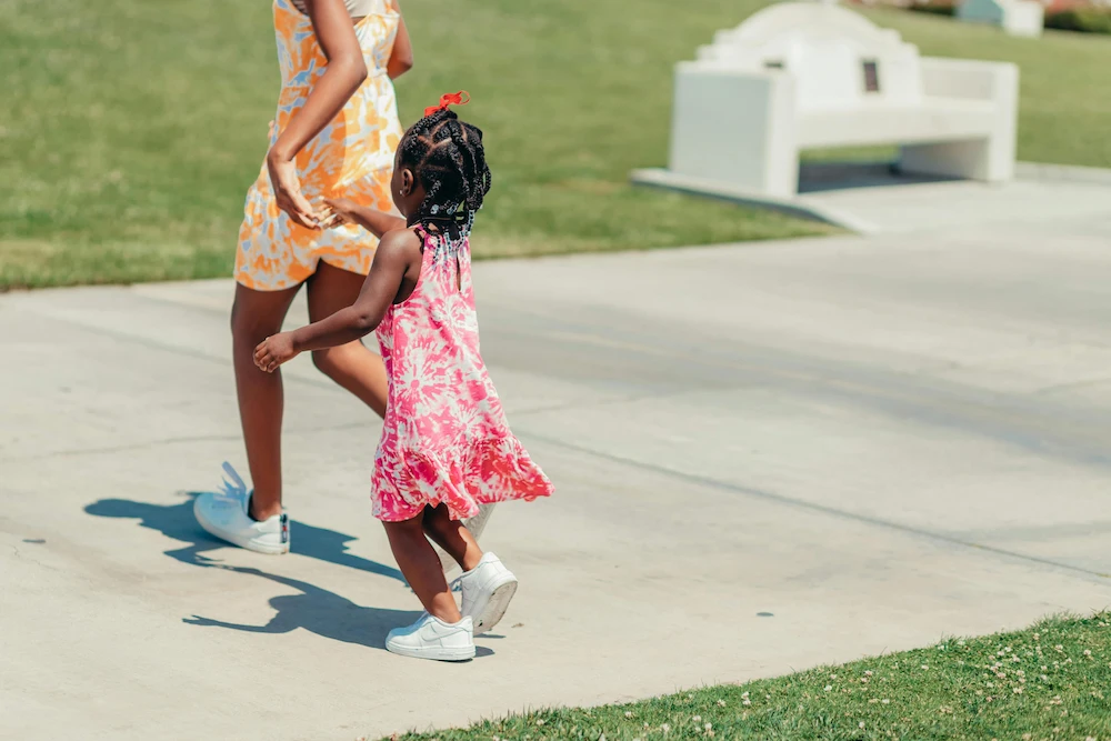 Baby girl playing on decorative colored concrete surface