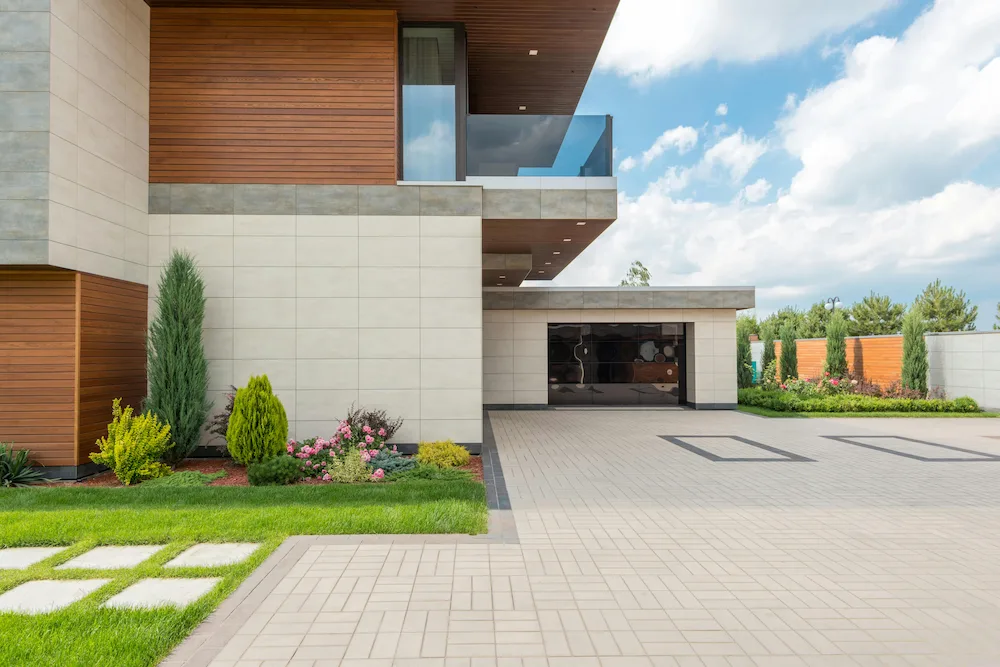 Thick concrete driveway installed in front of modern home