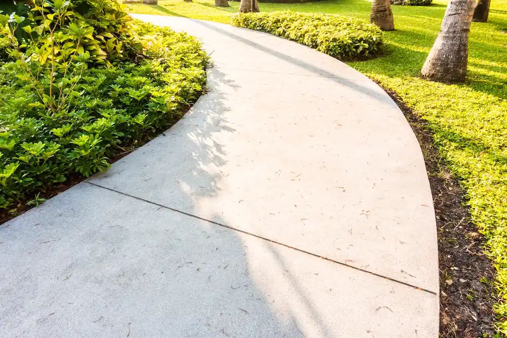 Fresh concrete driveway being poured and finished for a smooth and durable surface