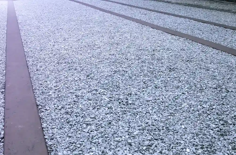 Concrete driveway beside a gravel driveway for comparison